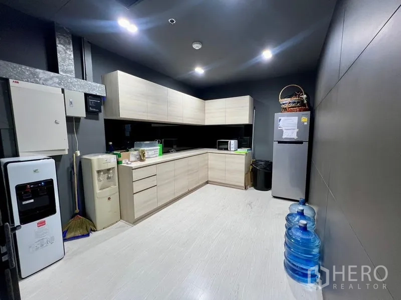Office Space for rent in Watthana, Bangkok - Staff kitchenette with L-shaped cabinets, refrigerator and water dispensers.