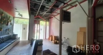 พื้นที่ขายปลีก ให้เช่าในKhlong Toei, Bangkok - พื้นที่ภายในร้านสไตล์ลอฟต์ เพดานเปิด โครงท่อสีแดง ประตูกระจก และม้านั่งบิลท์อิน