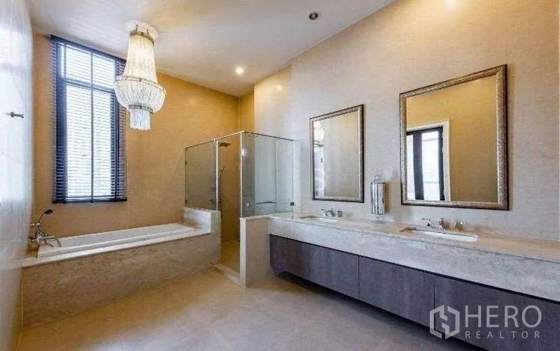 Condominium for rent - Luxury bathroom with bathtub, glass-enclosed shower and double-sink vanity.