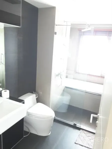 คอนโด ให้เช่าในKhlong Toei, Bangkok - ห้องน้ำสมัยใหม่พร้อมห้องอาบน้ำกระจก สุขภัณฑ์ และอ่างล้างหน้าใกล้หน้าต่าง