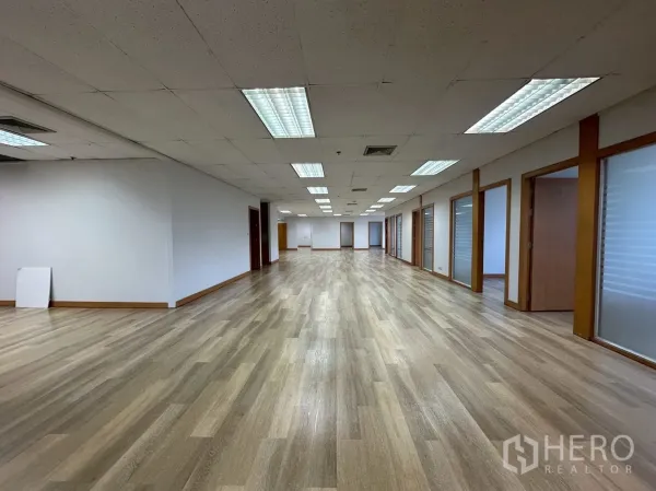 สำนักงาน ให้เช่า - โถงทำงานยาว พร้อมประตูกระจกหลายบานและพื้นไม้โทนอุ่น