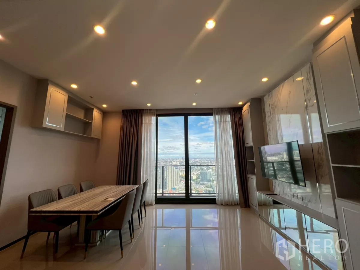 Condominium for rent in Phra Khanong, Bangkok - Living area with large sliding glass doors to balcony, dining table for six, and panoramic Bangkok city view.