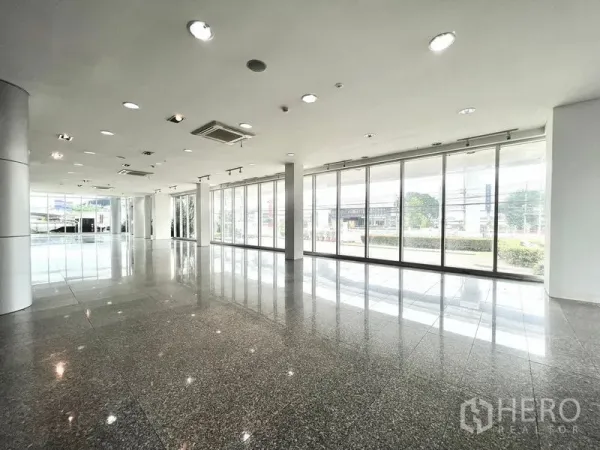 Retail Space for rent in Prawet, Bangkok - Showroom area with floor-to-ceiling glass frontage overlooking the street and greenery.