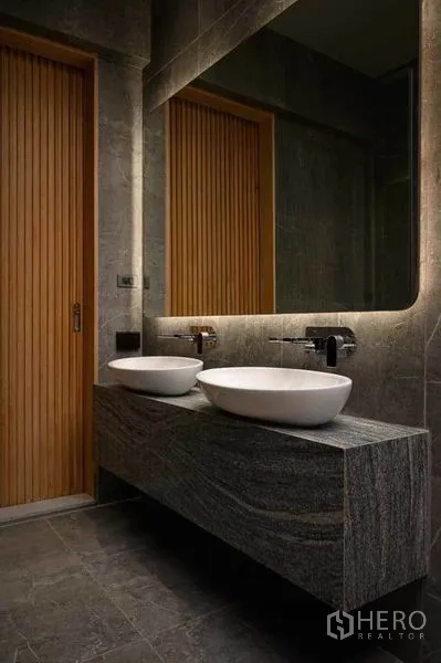 Home Office for sale in Wang Thonglang, Bangkok - Designer bathroom with stone vanity, dual vessel sinks and backlit mirror.