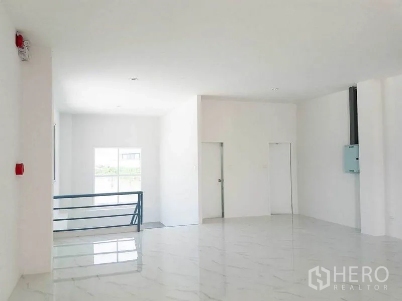 Warehouse for rent in Samut Prakan - Second-floor office space with white tiled floors and abundant natural light.