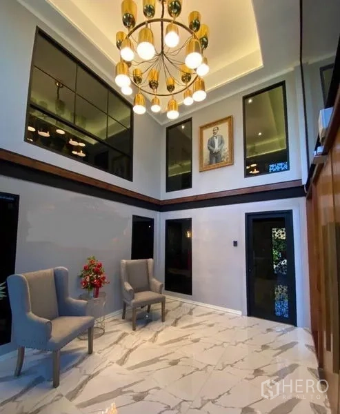 Warehouse for sale in Min Buri, Bangkok - Double-height lobby with chandelier, marble-look flooring and seating area.