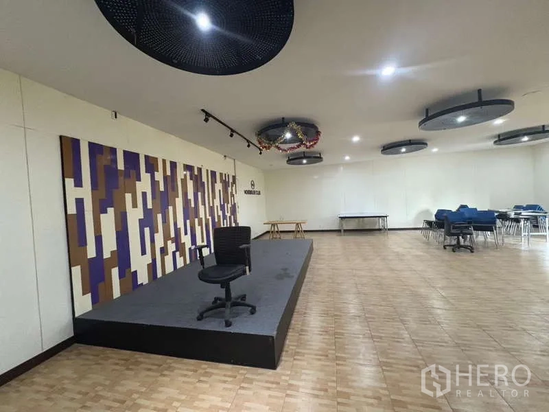 Office Space for rent in Khlong Toei, Bangkok - Spacious multipurpose hall with a small stage, seating and ceiling feature lights.
