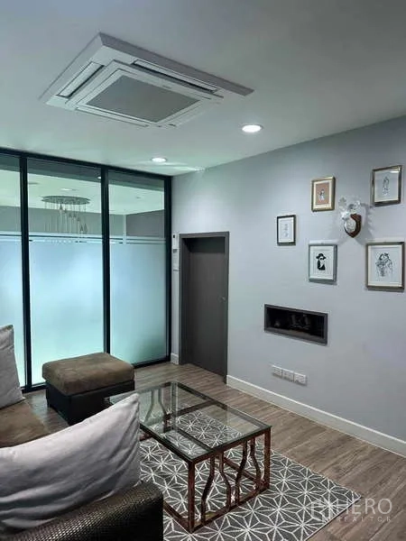 Home Office for rent in Bueng Kum, Bangkok - Ground-floor waiting area with sofa, glass partition, and ceiling cassette air conditioner.