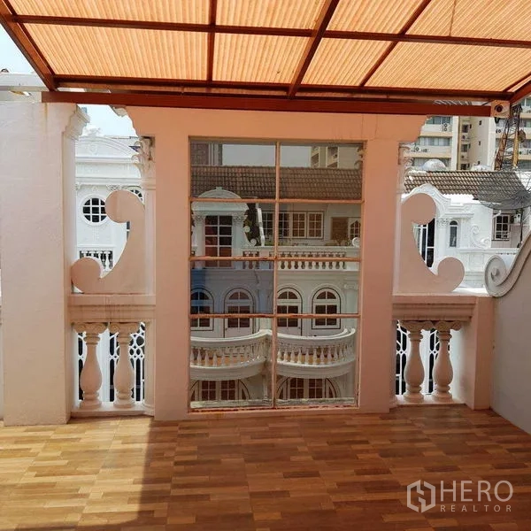 Home Office for rent in Watthana, Bangkok - Terrace with large framed opening and balustrade facing classic buildings.