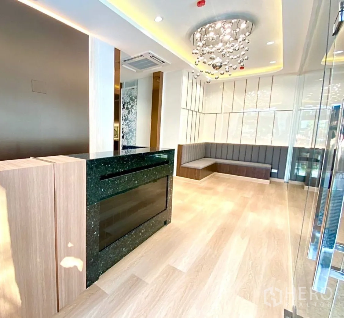 Office Space for rent - Reception zone featuring black granite counter, corner bench seating and accent lighting.