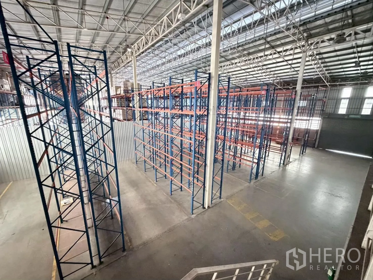 Warehouse for rent in Bang Sue, Bangkok - Elevated view of storage racks and open floor area inside the warehouse.