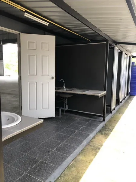 Warehouse for rent in Lat Lum Kaeo, Pathum Thani - Row of outdoor toilet stalls and handwashing area under a covered roof.