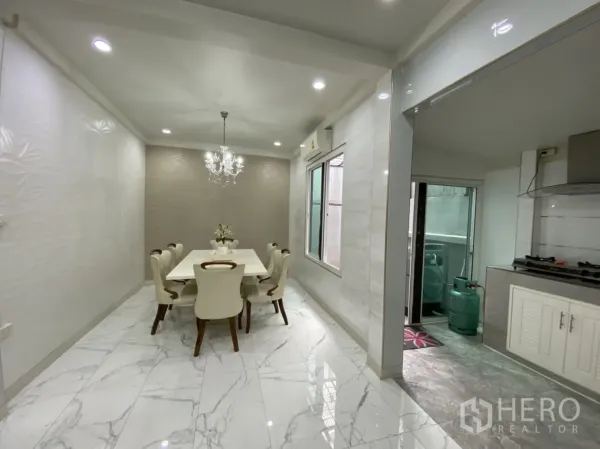 联排别墅 出租或出售 - 明亮餐区，水晶吊灯与大理石纹地砖，紧邻厨房。