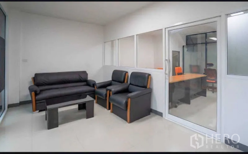 Home Office for rent or sale in Lat Krabang, Bangkok - Lounge area adjacent to a glass-partitioned workspace.