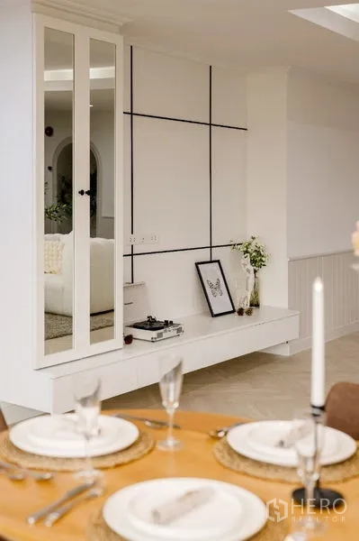 Condominium for sale - Elegant table setting beneath a gold chandelier in the dining area.