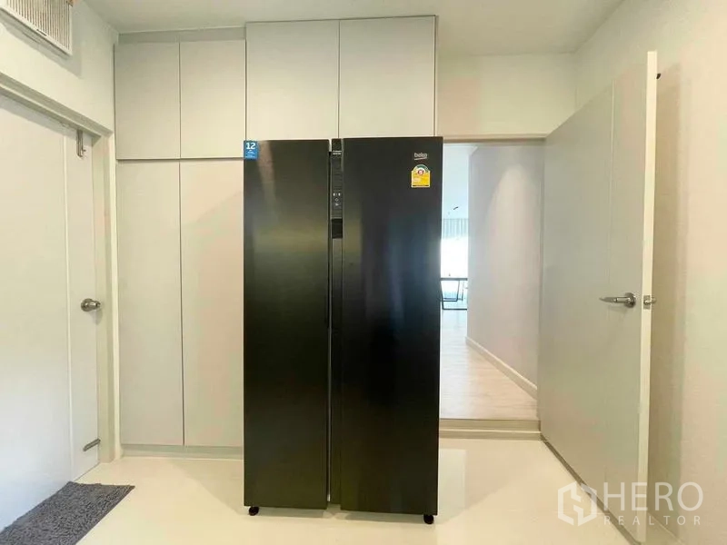 Detached House for rent in Bang Phli, Samut Prakan - Pantry area with tall storage cabinets and a black side-by-side refrigerator.