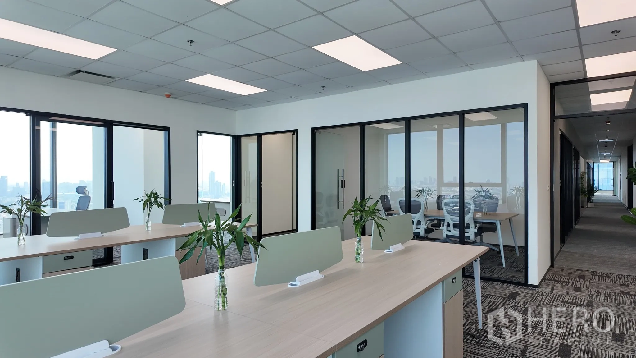Office Space for rent in Khlong Toei, Bangkok - Hallway and glass-fronted meeting rooms beside workstations in a modern office.