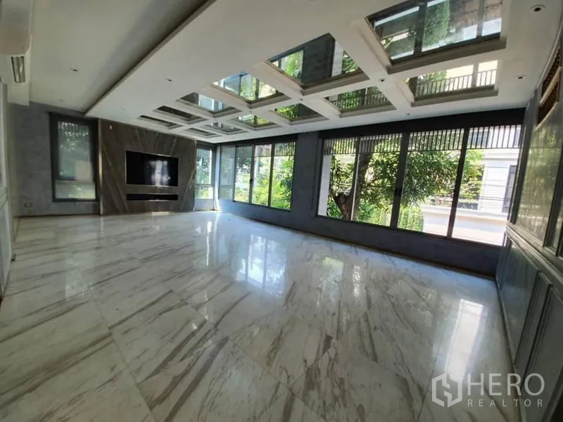 Office Space for rent in Khlong Toei, Bangkok - Sunlit open-plan workspace with marble flooring and panoramic windows.