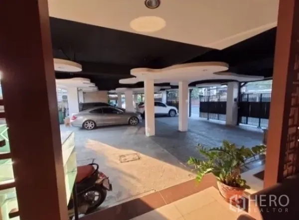 Home Office for rent - Covered ground-level parking with multiple columns and a secure gate at the home office building.