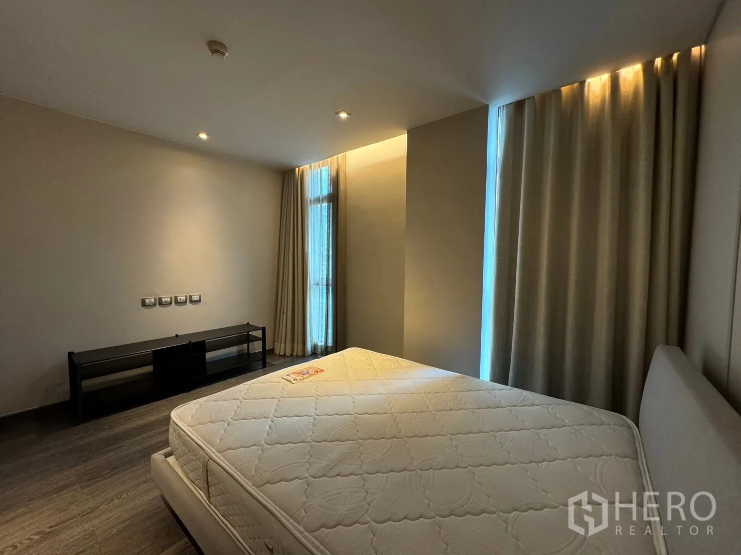 Condominium for rent - Third bedroom with large windows, neutral décor and soft lighting.