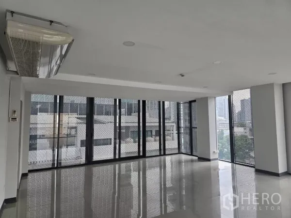 Office Space for rent in Sathon, Bangkok - Corner workspace featuring wraparound glazing, ceiling-mounted air conditioning, and abundant natural light.