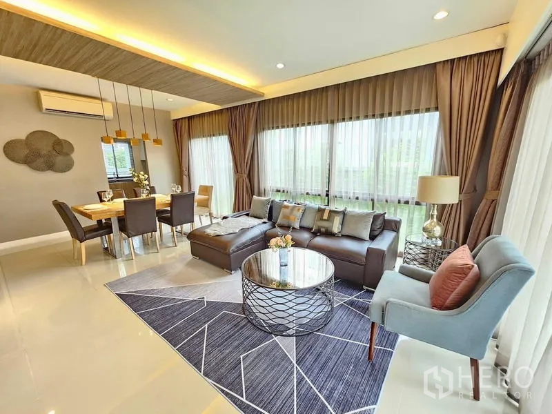 Detached House for rent in Prawet, Bangkok - Open living–dining area with expansive windows and contemporary decor.