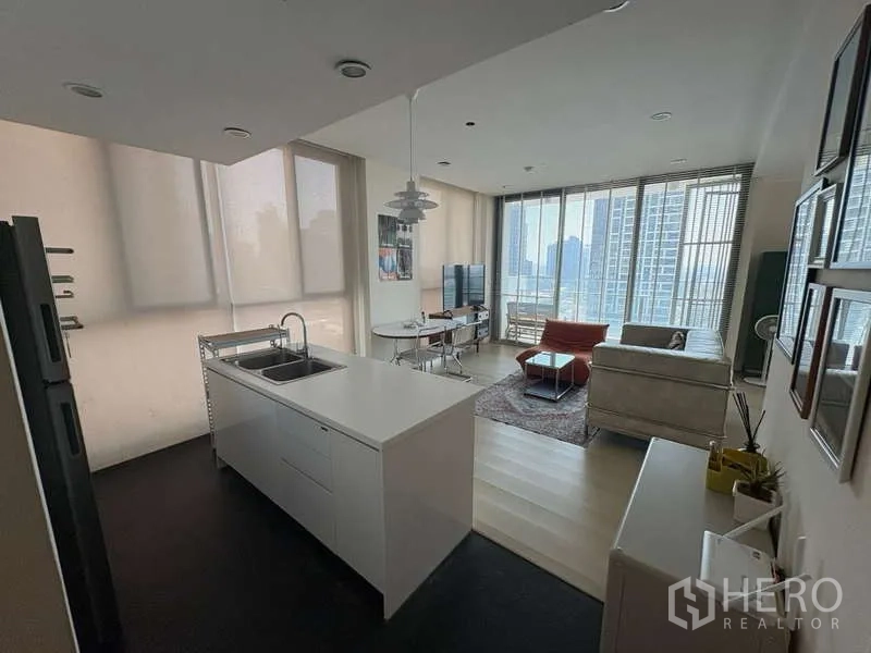 Condominium for rent - Open kitchen with island facing the living-dining area and tall windows.