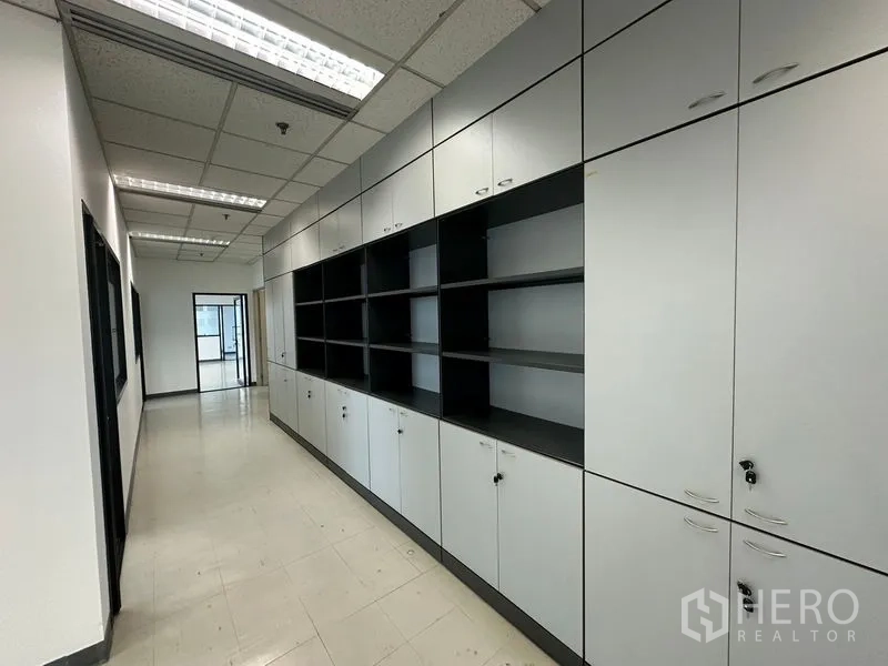 Office Space for rent in Khlong Toei, Bangkok - Hallway lined with built-in cabinets and open shelving for files and equipment.