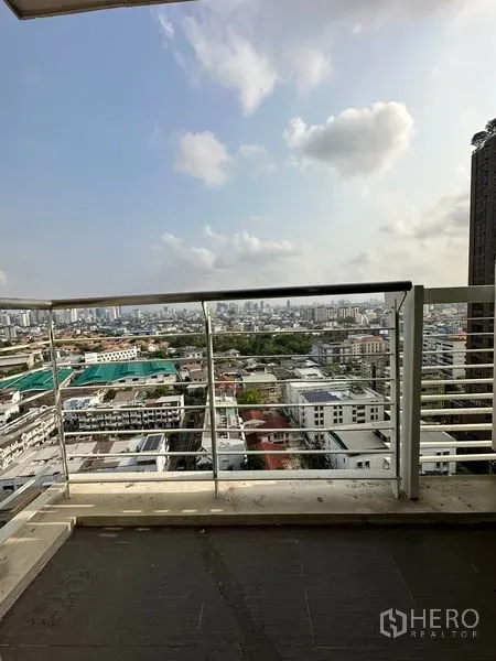 Condominium for sale in Watthana, Bangkok - Private balcony with railing overlooking Bangkok skyline and neighborhood.