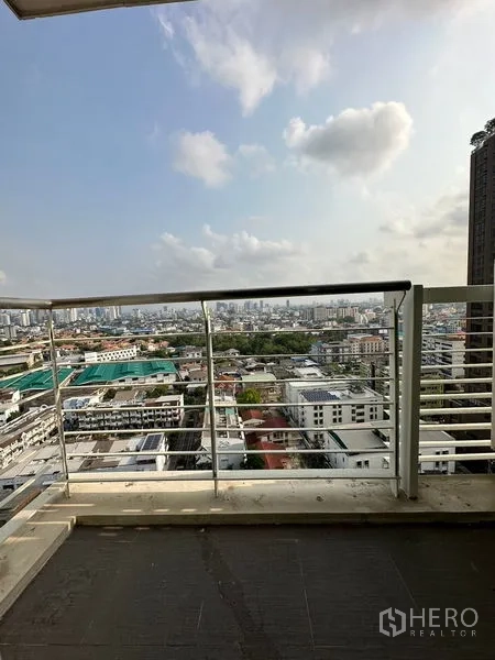 Condominium for sale in Watthana, Bangkok - Private balcony with railing overlooking Bangkok skyline and neighborhood.