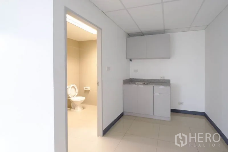 Office Space for rent in Suan Luang, Bangkok - Bright corner of the office with broad windows and an internal door.