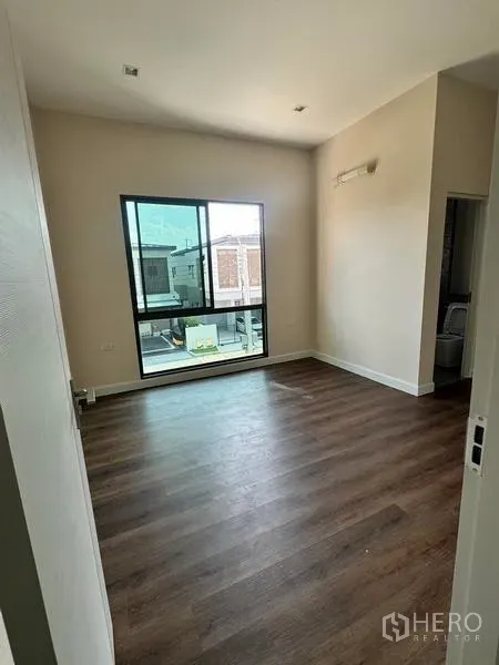 Detached House for rent or sale - Bright bedroom with large window, wood-look flooring and access to an ensuite.