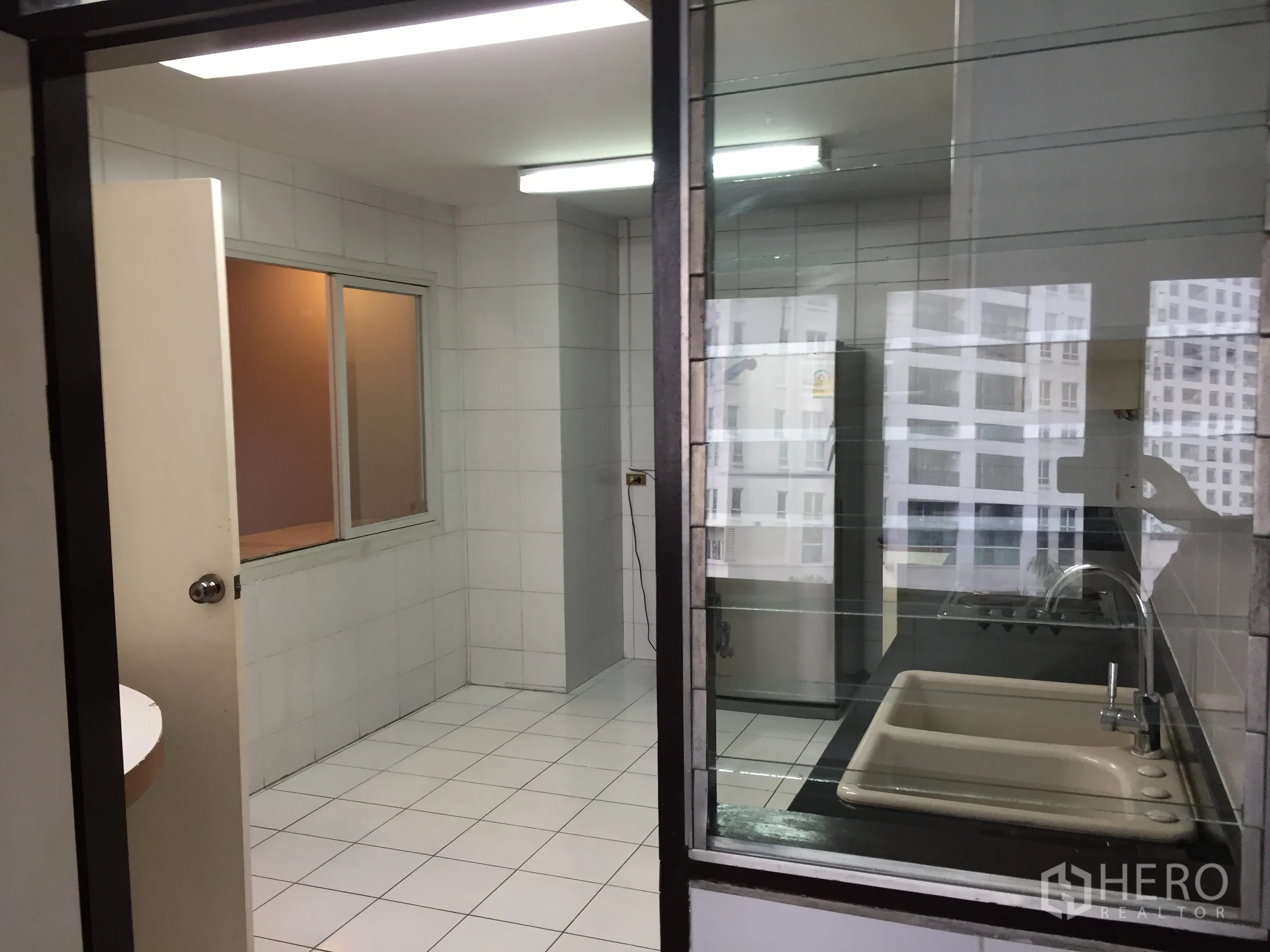 คอนโด ให้เช่าในWatthana, Bangkok - ครัวและโซนซักล้างกั้นกระจก มองเห็นวิวเมืองย่านนานา