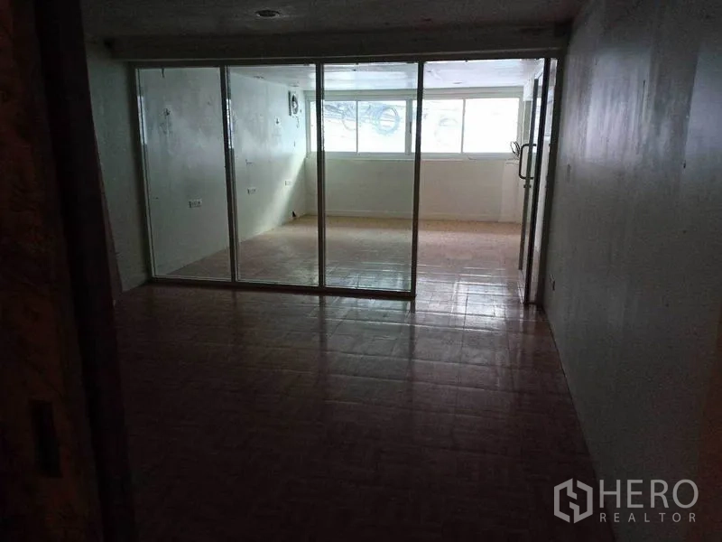 零售空间 出租在Watthana, Bangkok - 店内玻璃隔断房，窗户引入自然采光。