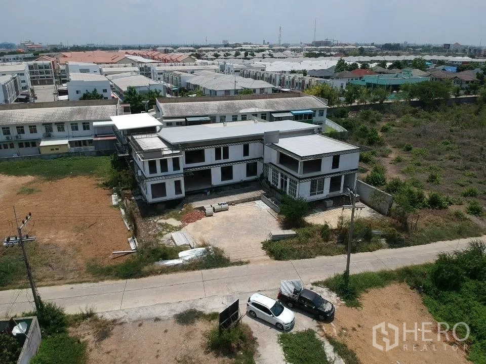 Land for sale in Phra Nakhon Si Ayutthaya, Phra Nakhon Si Ayutthaya - Oblique aerial of the property showing the building, parking area, and surrounding residential neighborhood.