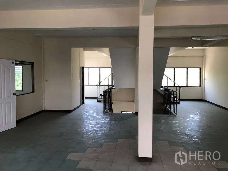 Shophouse for sale in Lam Luk Ka, Pathum Thani - Upper floor landing with twin staircases and bright open area.