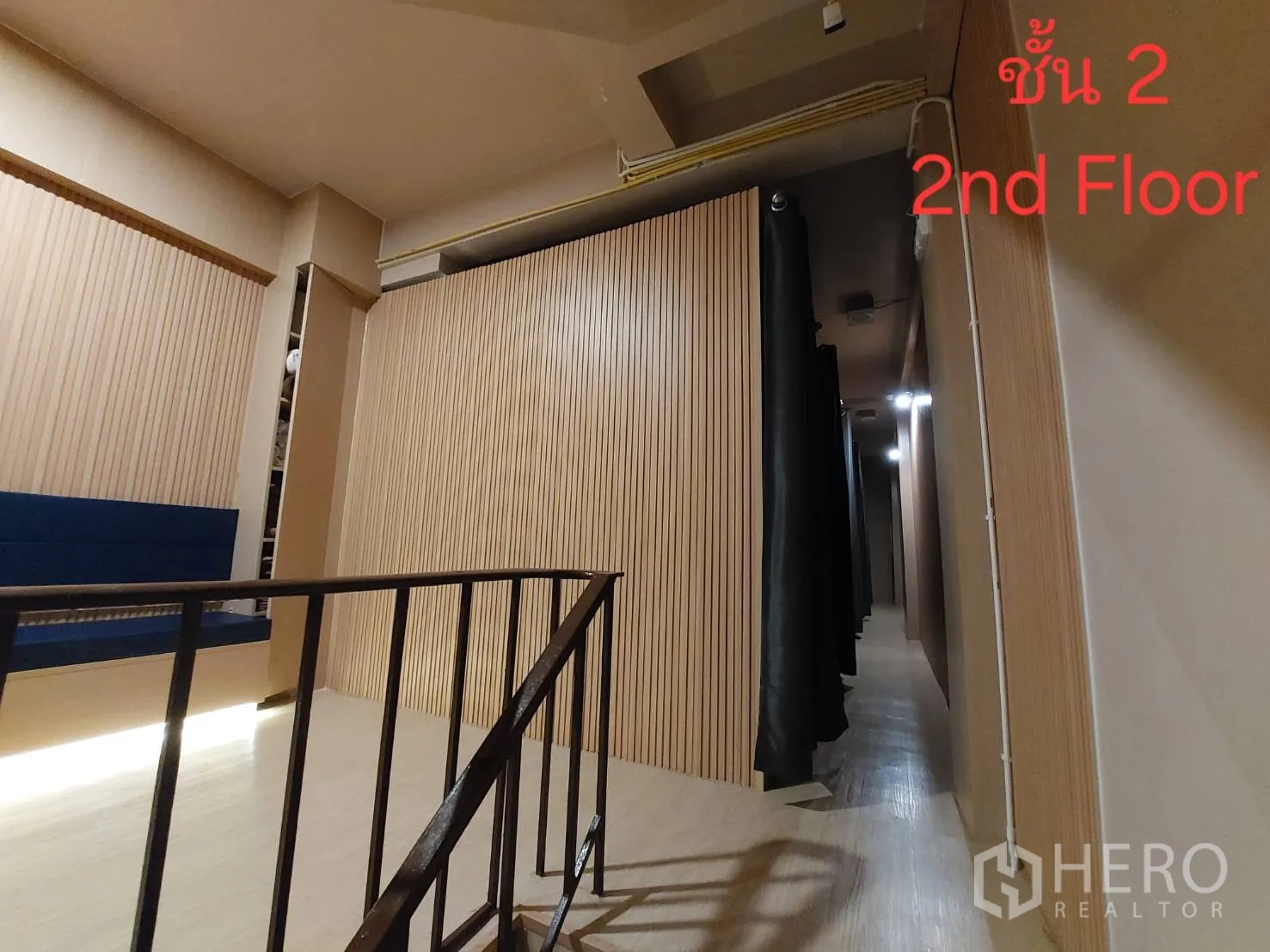 店屋 出租或出售在Watthana, Bangkok - 二楼楼梯平台与木质墙面走廊，挂有窗帘。