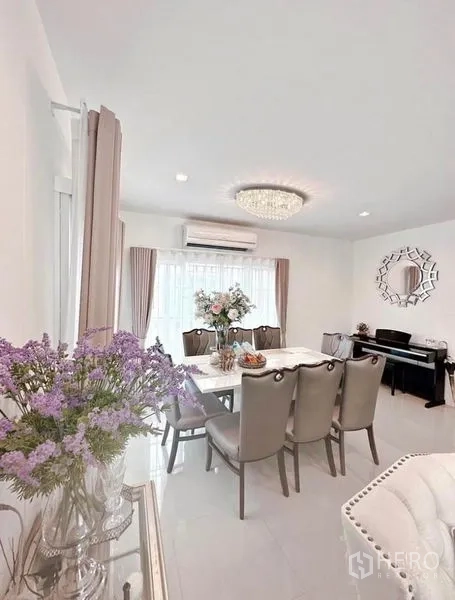 Detached House for rent in Bueng Kum, Bangkok - Bright dining and living area with chandelier, air conditioning and large windows with sheer curtains.