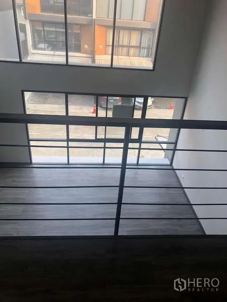 Home Office for rent or sale - View from the mezzanine over the double-height room to floor-to-ceiling front windows and street.