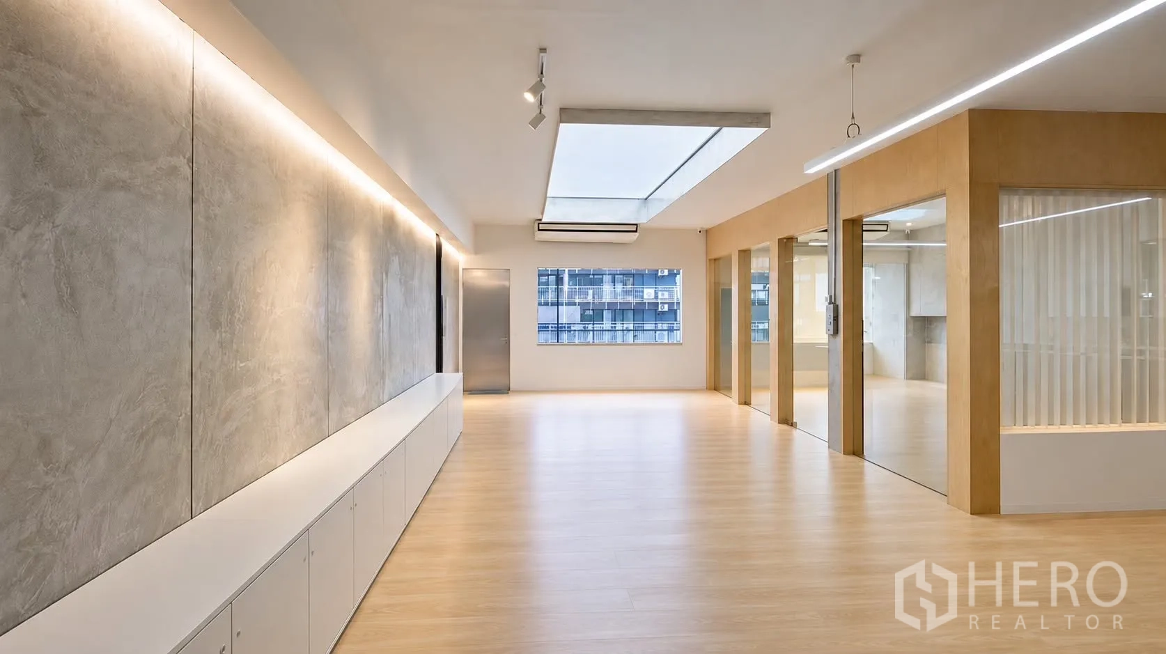 Retail Space for rent in Watthana, Bangkok - Spacious hall with wood floors, a large skylight, window, and glass-walled rooms.