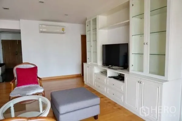 Condominium for rent in Watthana, Bangkok - Lounge corner featuring a white built-in TV cabinet with glass display shelving.