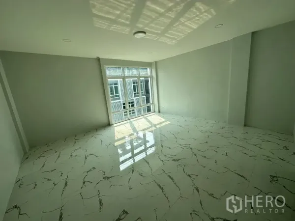 Home Office for rent or sale - Spacious room with glossy marble-effect flooring and a wide window for natural light.