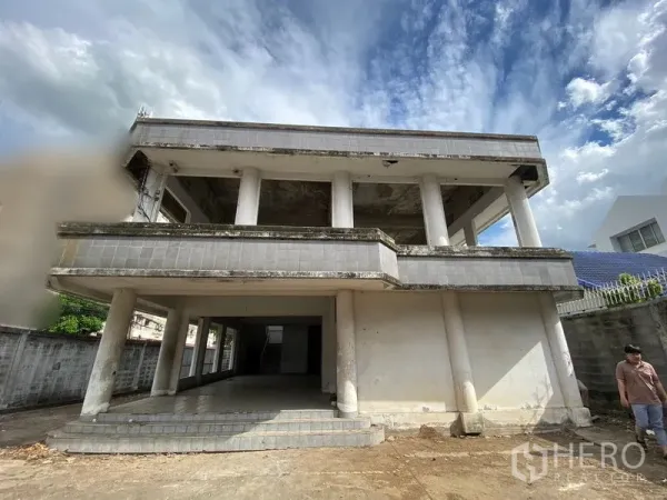 Office Space for sale in Wang Thonglang, Bangkok - Two-storey concrete office building with columns and open balconies inside a walled compound.