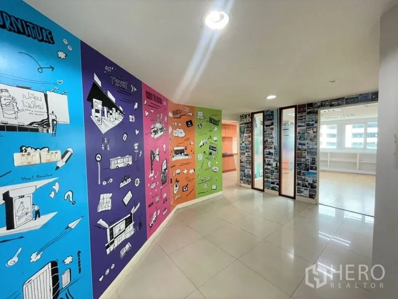 Office Space for rent in Chatuchak, Bangkok - Colorful mural corridor leading to glass-partitioned offices with natural light.