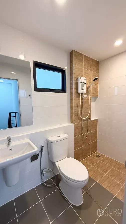 Townhouse for rent in Bang Phli, Samut Prakan - Bathroom with window, rain shower, water heater and sink.