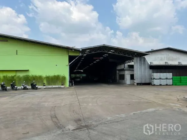 Warehouse for rent - Exterior of the warehouse complex with covered loading bay and wide paved yard.