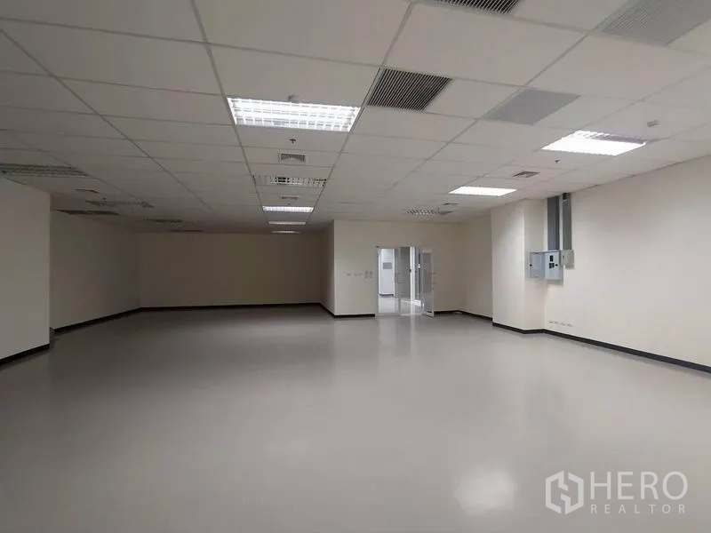 Office Space for rent in Bang Na, Bangkok - Open-plan office space with ceiling air vents, LED panels and utility boxes.