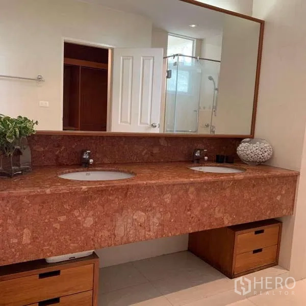 独立式住宅 出租在Lat Krabang, Bangkok - 主卫生间配长款大理石双盥洗台、超大镜面与收纳抽屉。