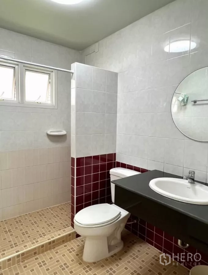 Detached House for rent or sale in Prawet, Bangkok - Third bathroom with walk-in shower, red tile wainscoting and vanity.