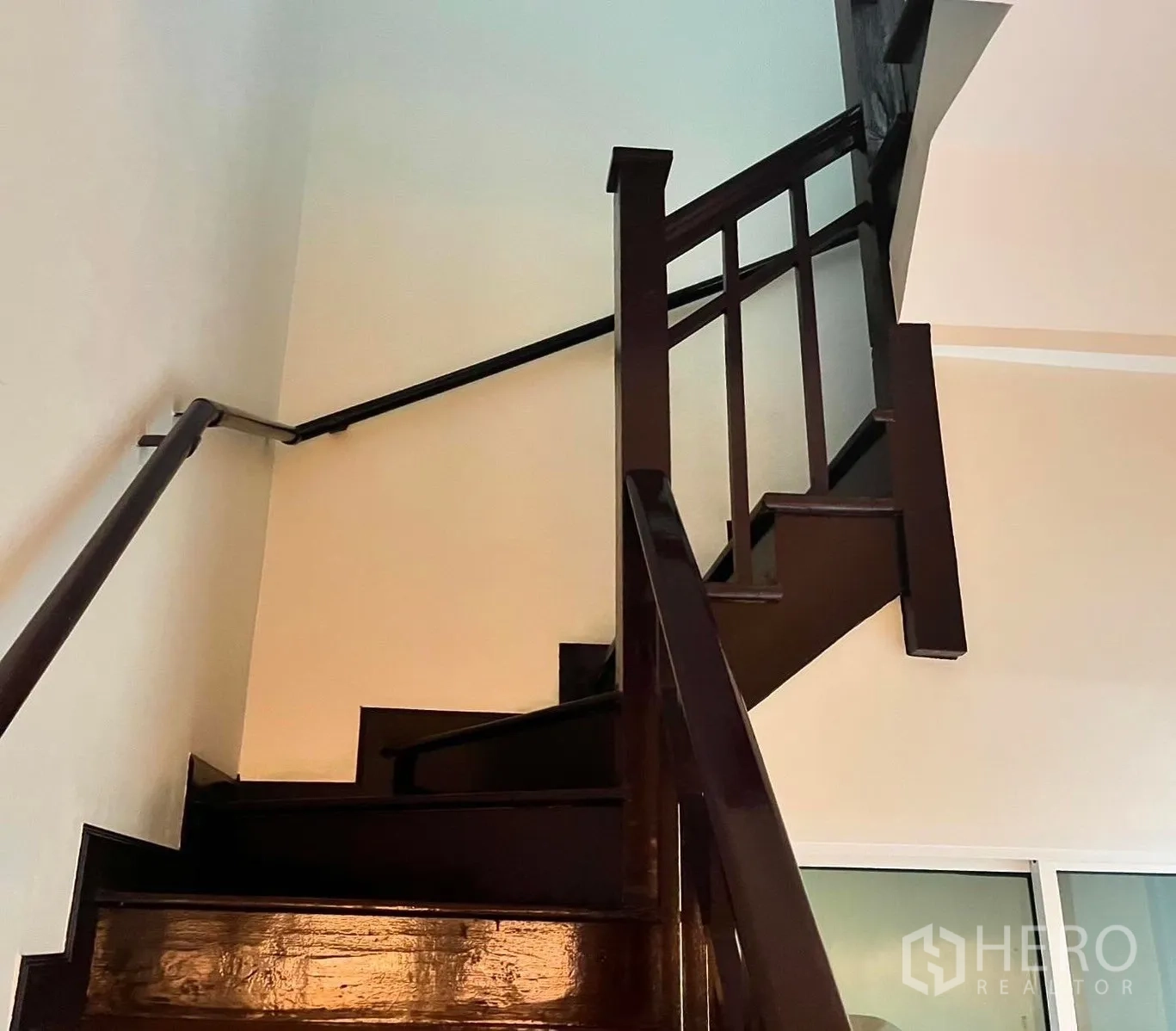 Shophouse for rent in Bang Rak, Bangkok - Dark wooden staircase with handrail leading to upper floor.